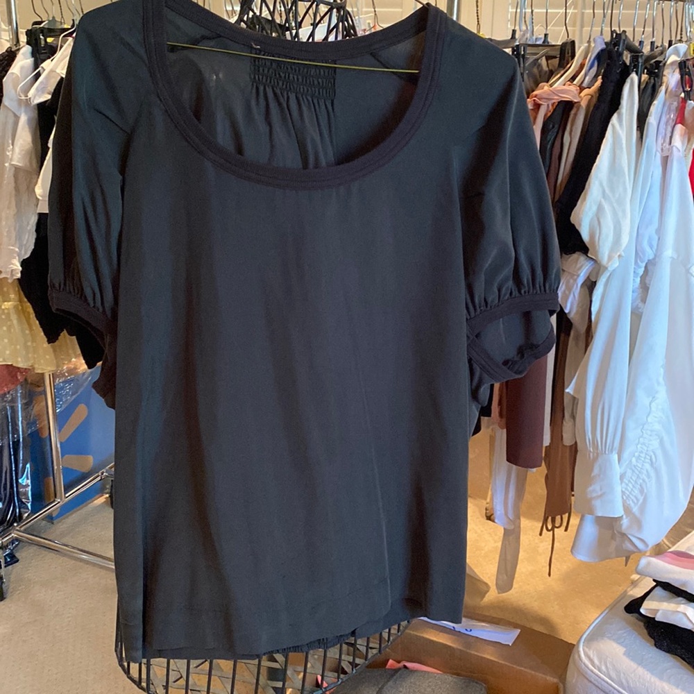 Black silk shirt sleeve top.